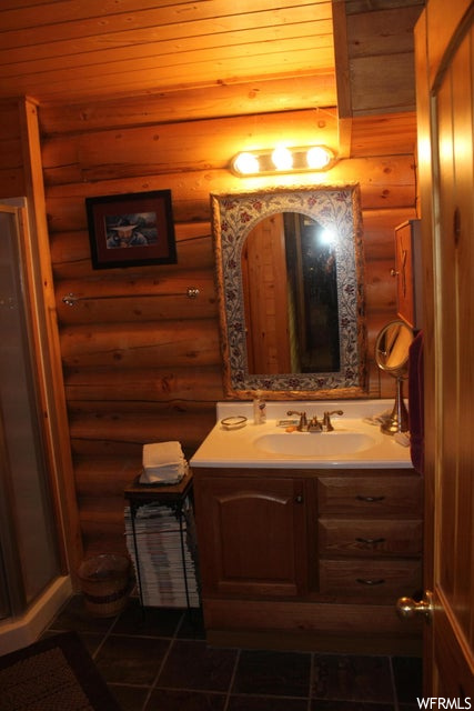 Bathroom featuring tile floors, mirror, and vanity
