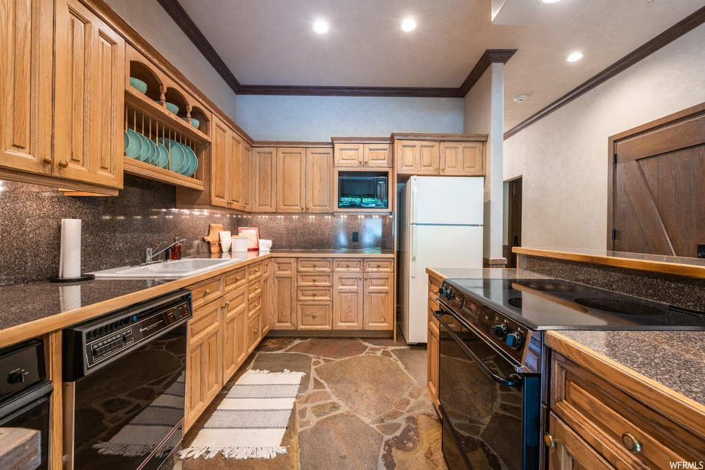 Kitchen featuring microwave, dishwasher, refrigerator, electric range oven, and brown cabinetry