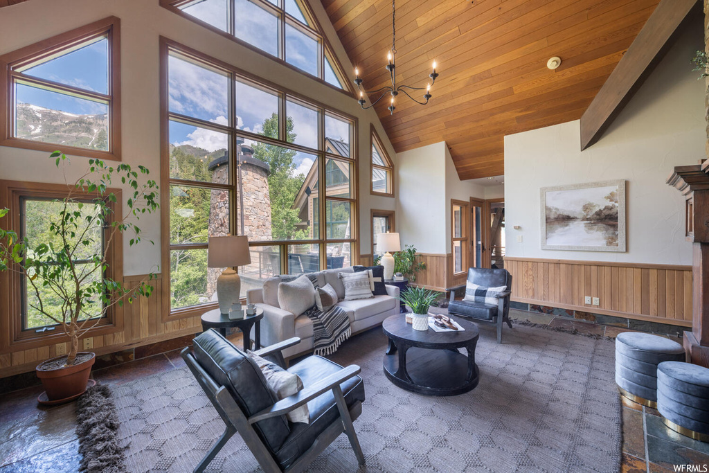 Living room with a wealth of natural light, a high ceiling, and lofted ceiling