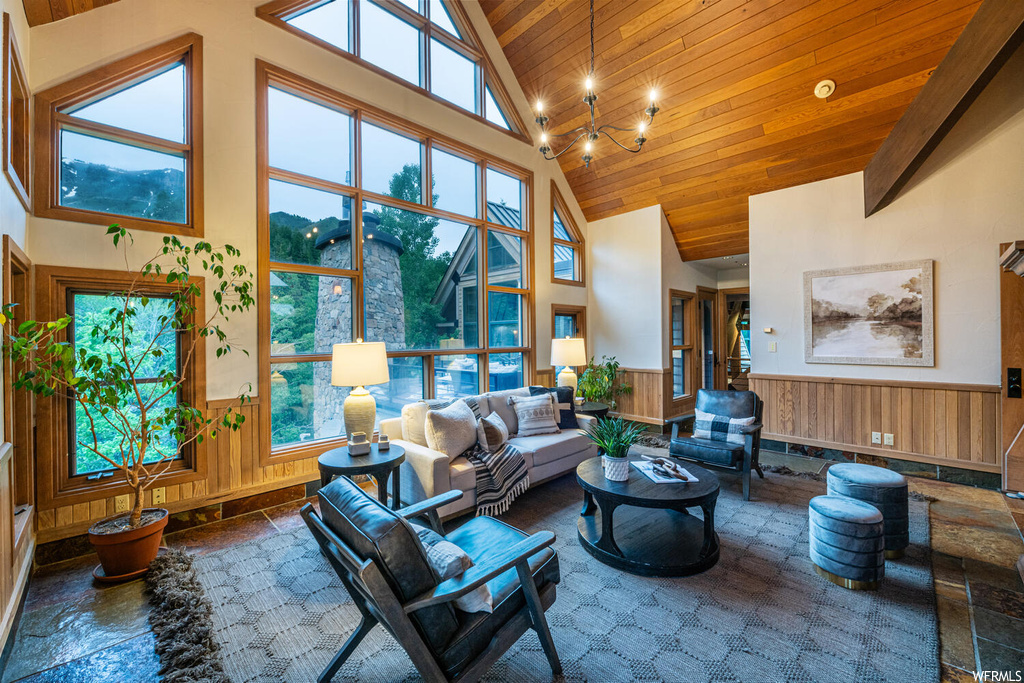 Living room featuring vaulted ceiling, a high ceiling, and natural light