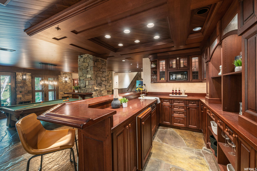 Bar with light tile floors and dark brown cabinetry