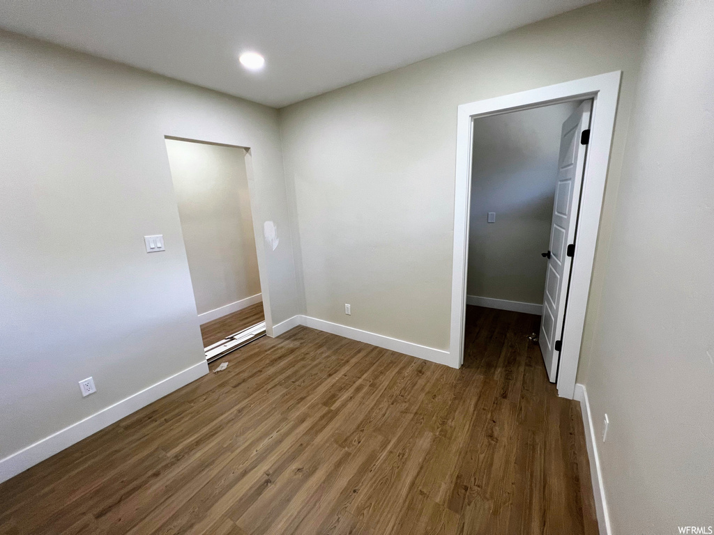 Empty room featuring hardwood floors