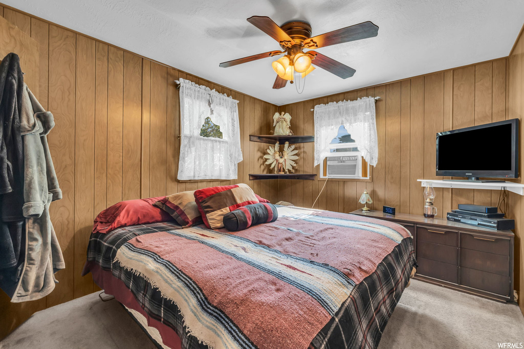 Bedroom featuring a ceiling fan, natural light, and TV