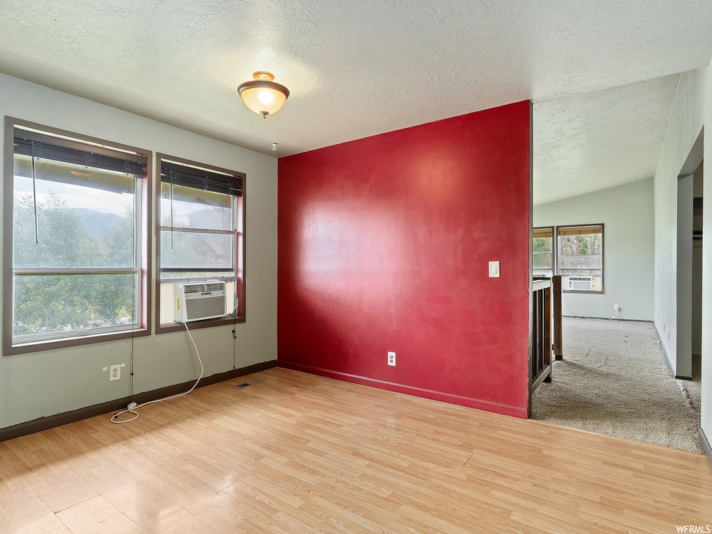 Carpeted spare room with natural light