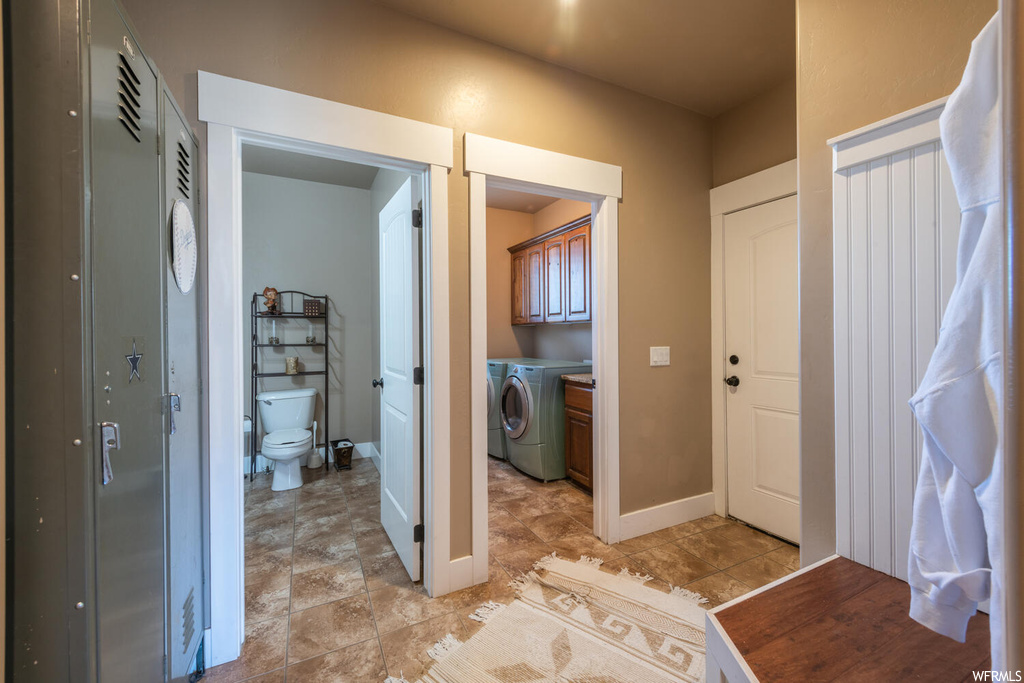 Interior space with tile flooring and washer / dryer