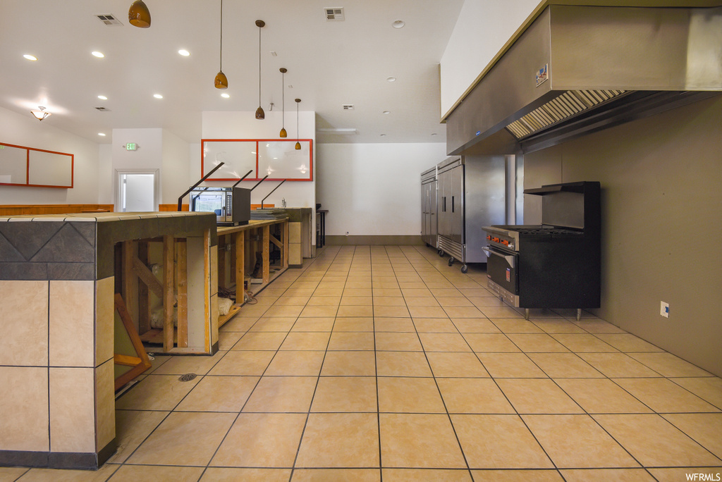 Kitchen with pendant lighting and light tile flooring