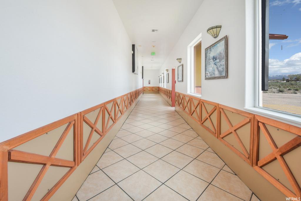 Corridor featuring tile flooring