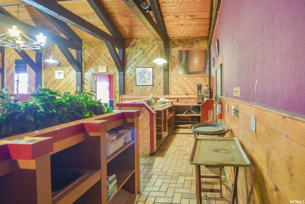 Kitchen featuring lofted ceiling with beams and light tile floors