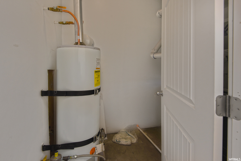 Utility room featuring water heater