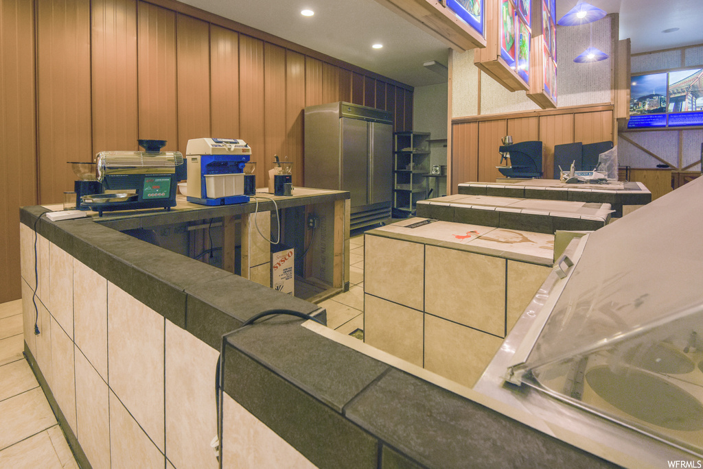 Kitchen with light brown cabinetry and light flooring