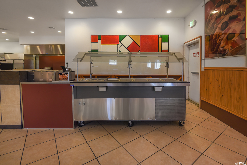 Kitchen featuring stainless steel finishes and light tile flooring