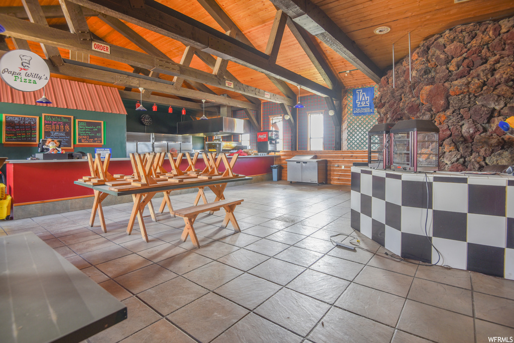 Tiled dining room with wood beam ceiling