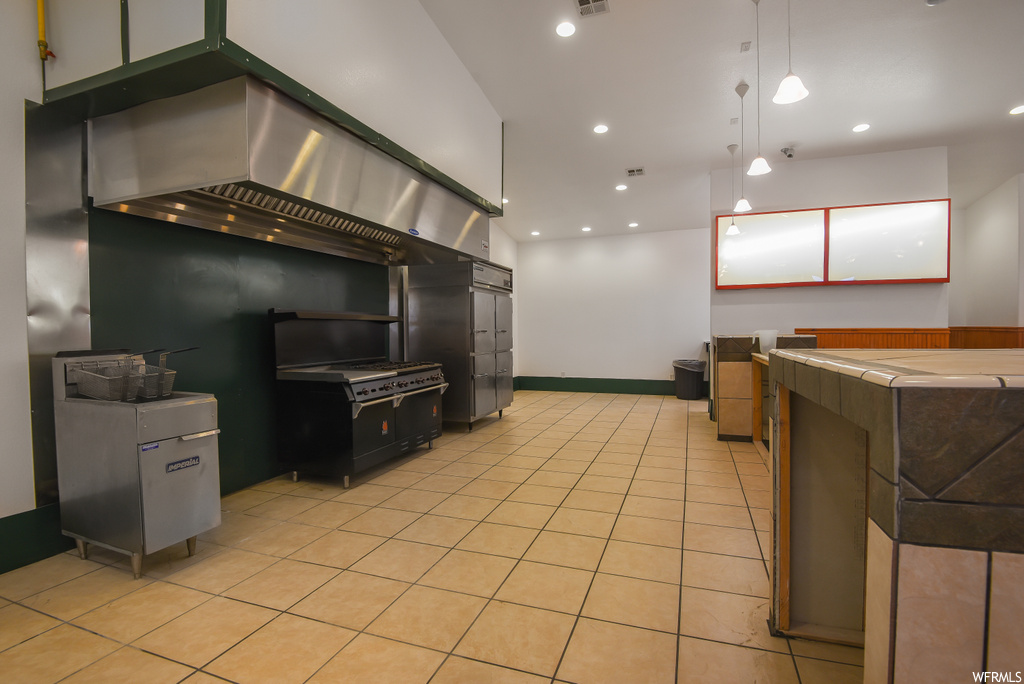 Kitchen featuring light tile floors and pendant lighting