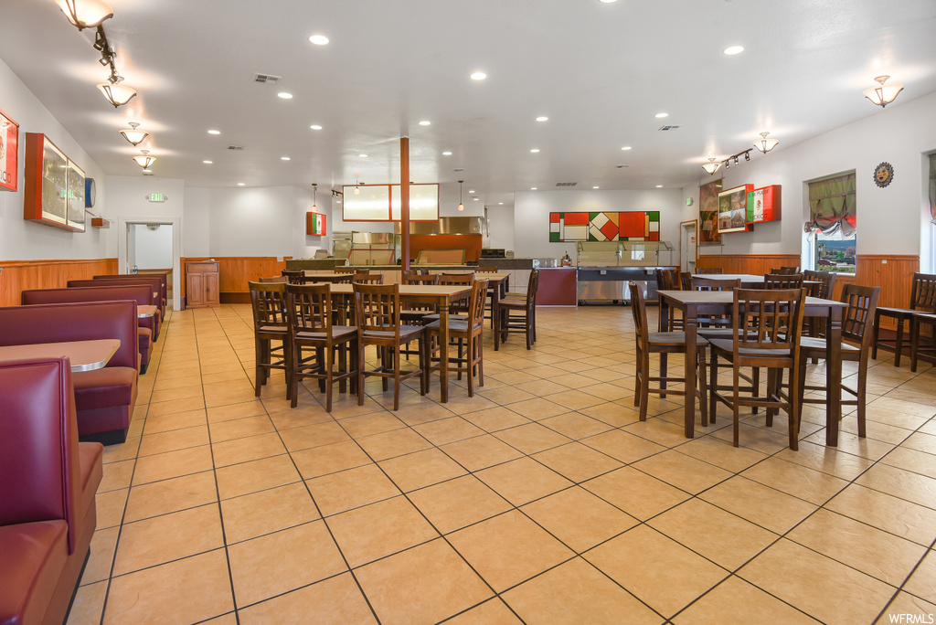 Dining area featuring tile floors and stainless steel finishes