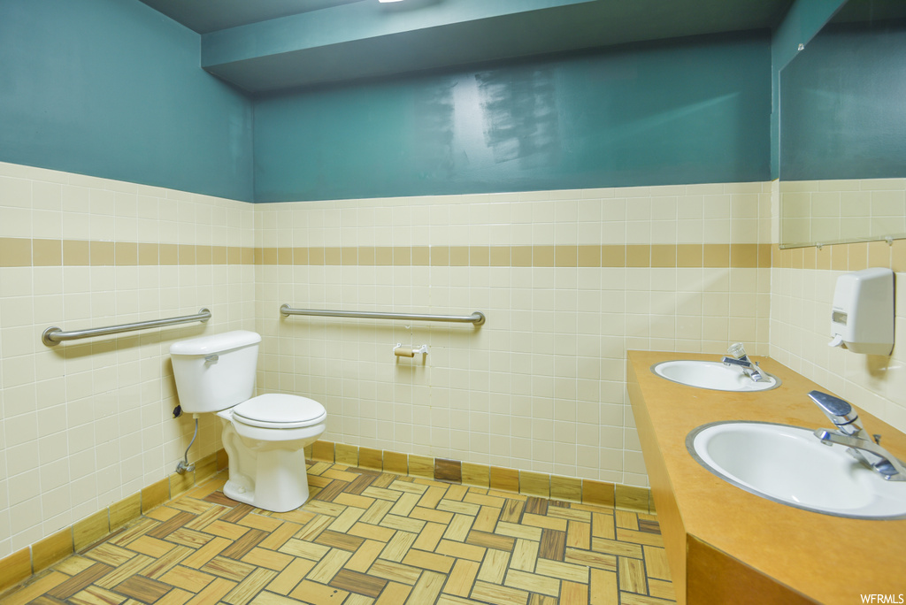 Bathroom with toilet and his and her sinks