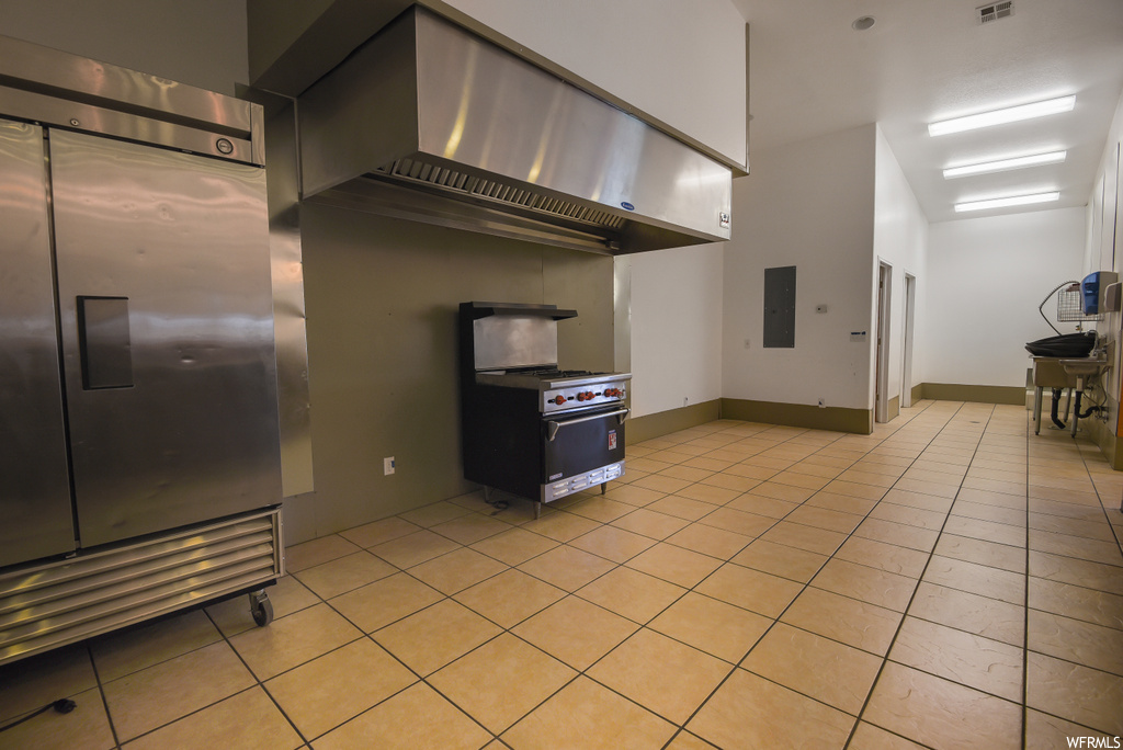 Kitchen featuring light tile floors