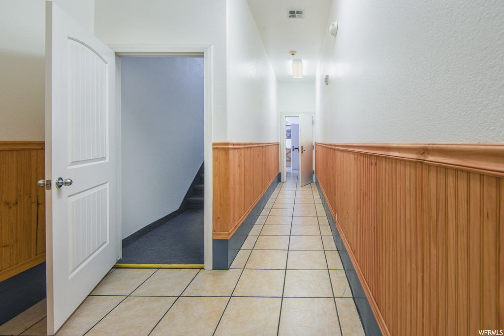 Corridor featuring tile flooring