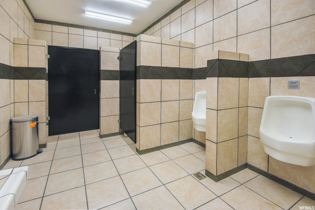 Half bath with tile flooring, toilet, and washbasin