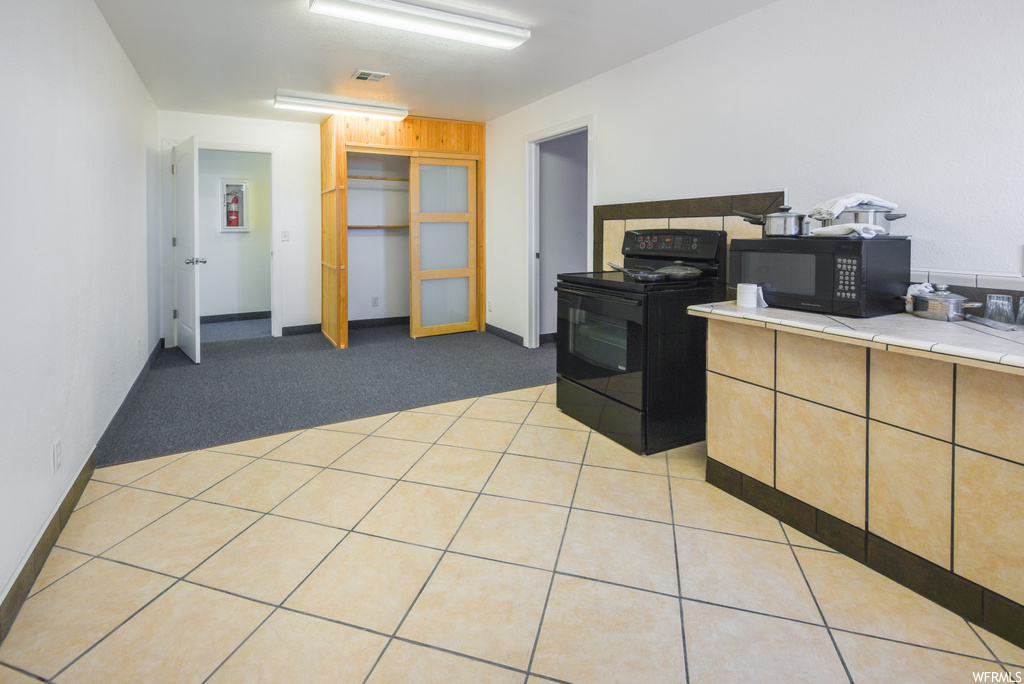 Carpeted office space featuring microwave