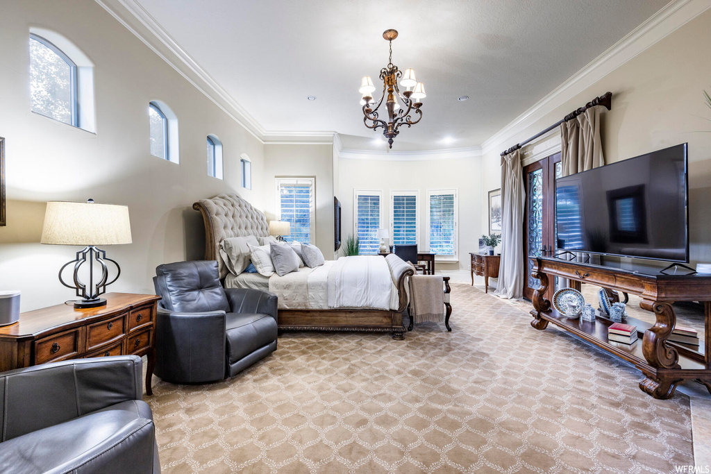 Bedroom with a chandelier, multiple windows, and crown molding