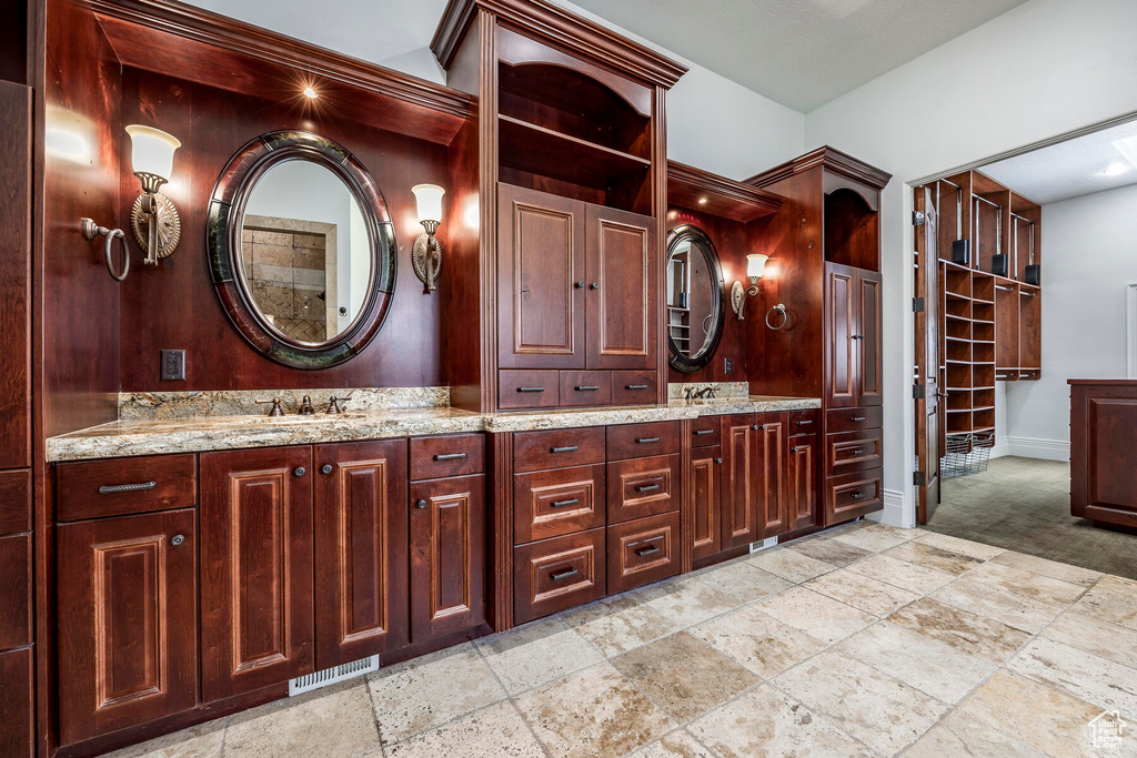 Bathroom featuring tile flooring, large vanity, and double sink