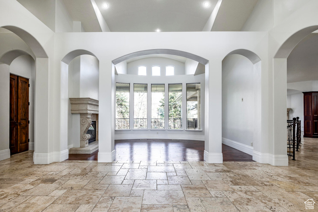 Entrance foyer with light tile flooring and high vaulted ceiling