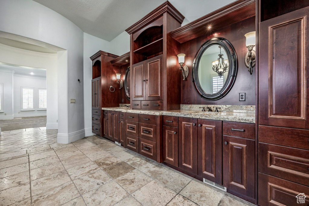 Bathroom with tile floors, dual sinks, and vanity with extensive cabinet space