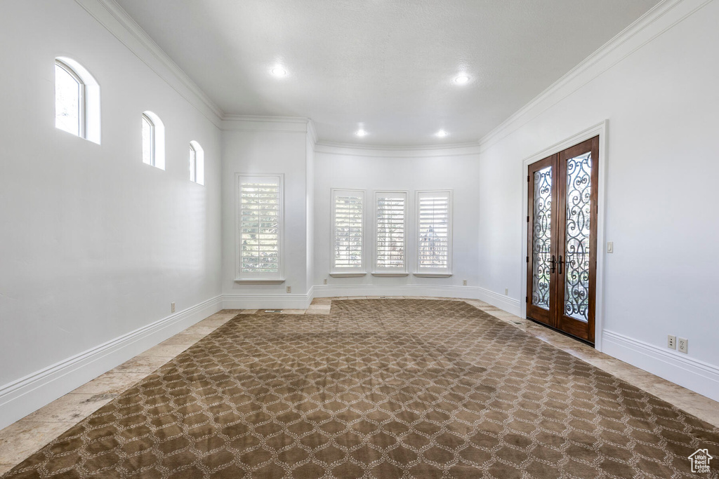 Entrance foyer with french doors and crown molding