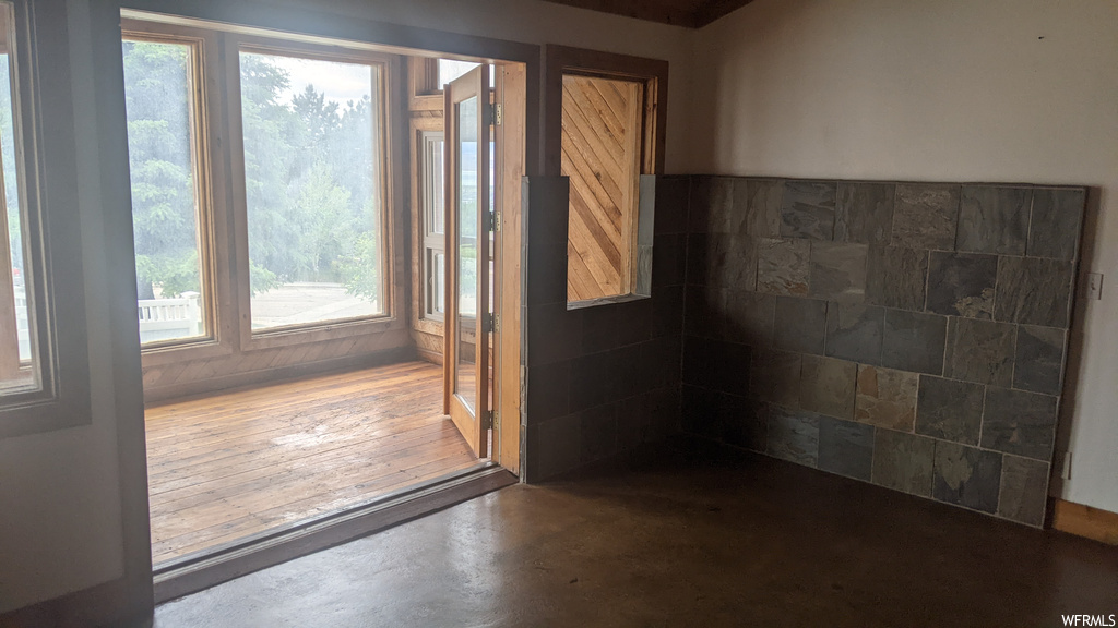 Doorway featuring hardwood floors and natural light