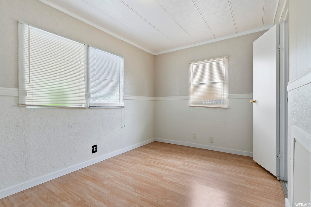 Empty room featuring hardwood flooring
