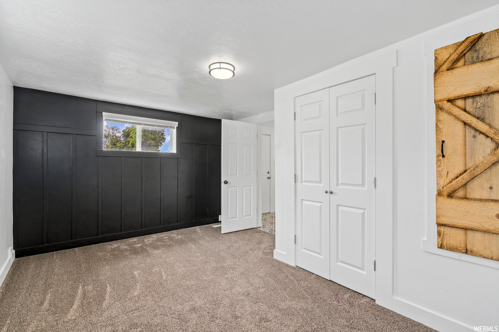 Carpeted bedroom with natural light
