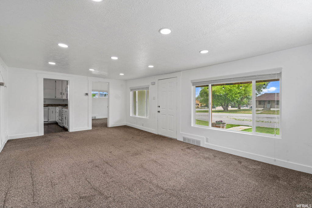 Living room featuring carpet and natural light