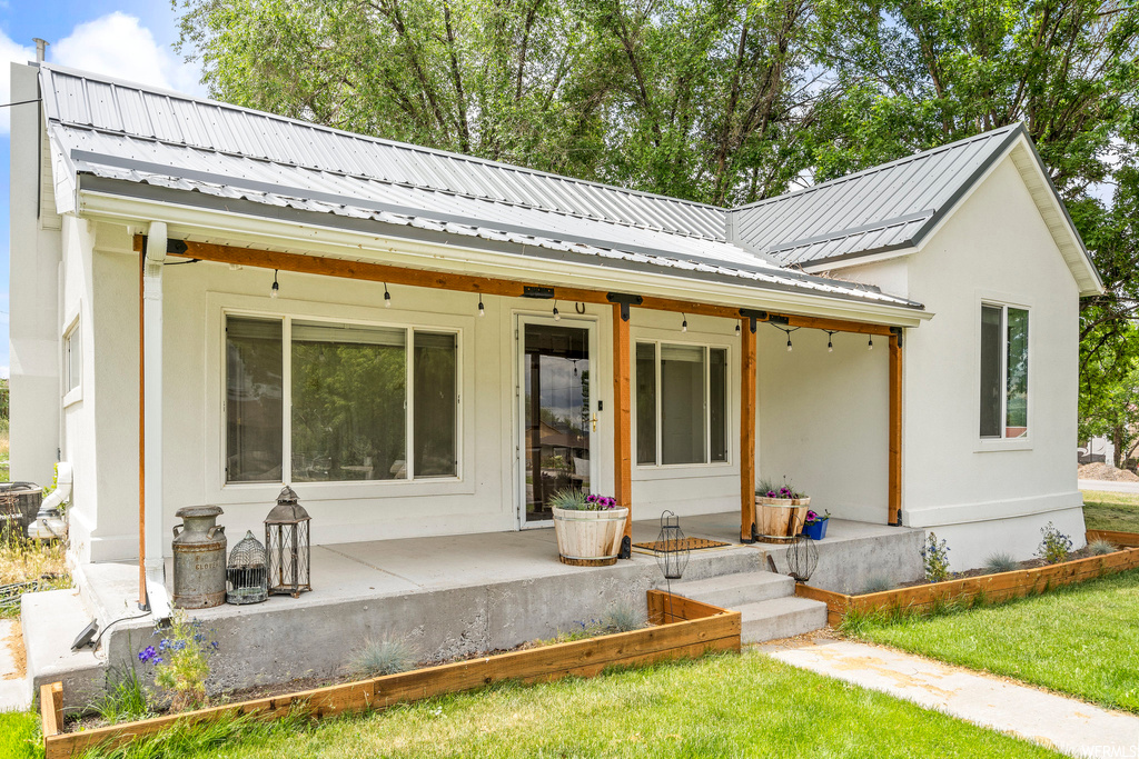 Back of house with a yard