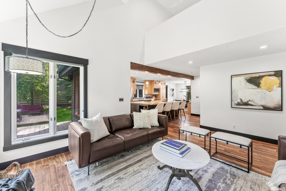 Living room featuring a kitchen bar and hardwood floors