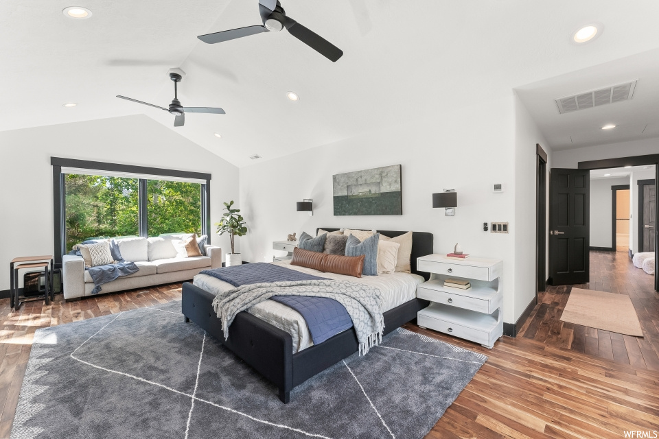 Bedroom featuring hardwood floors, lofted ceiling, natural light, and a ceiling fan