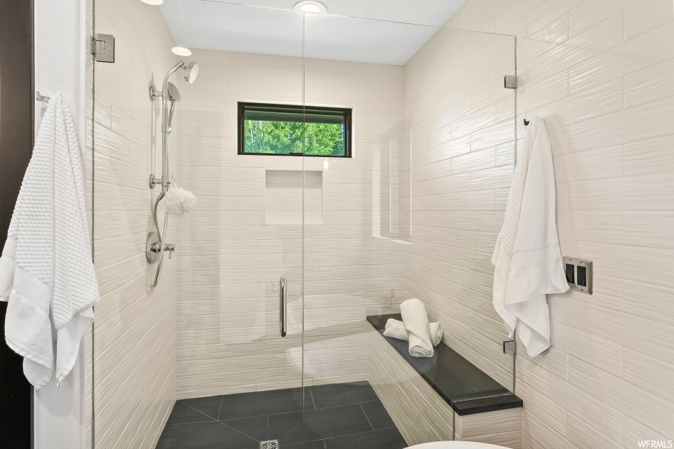Bathroom featuring tile floors, natural light, and shower cabin