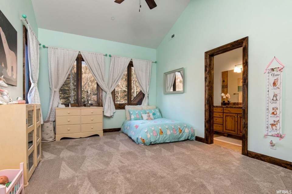 Bedroom with carpet and lofted ceiling