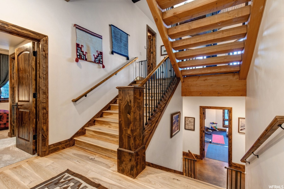Stairway featuring hardwood floors