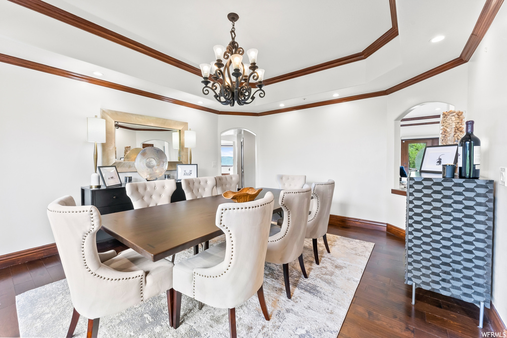 Dining area featuring hardwood floors, a chandelier, and plenty of natural light