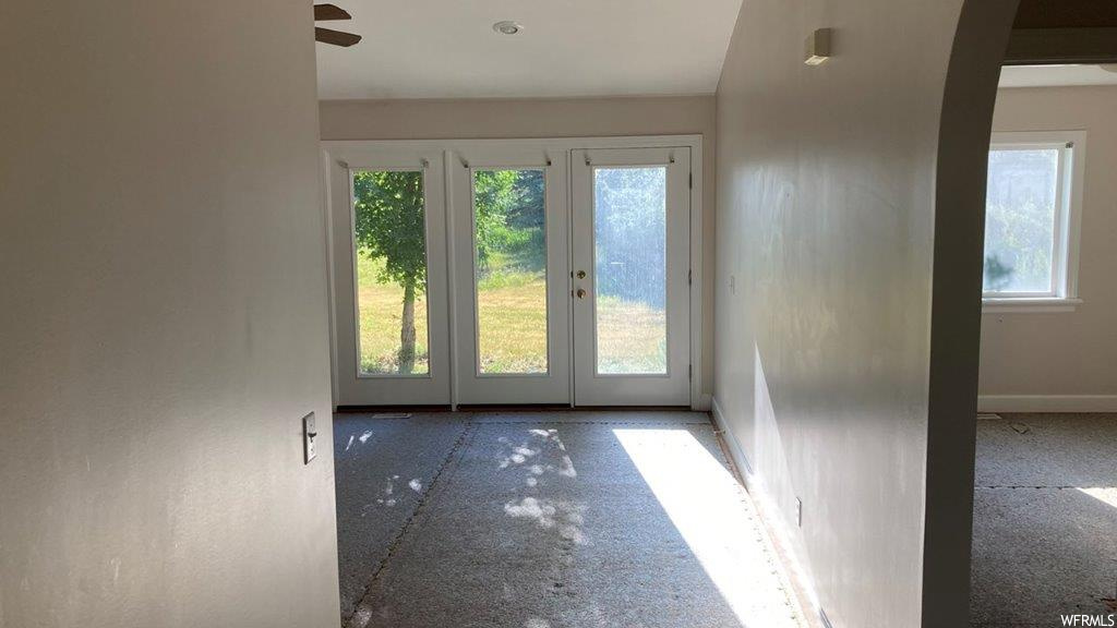Doorway to outside featuring a healthy amount of sunlight and french doors