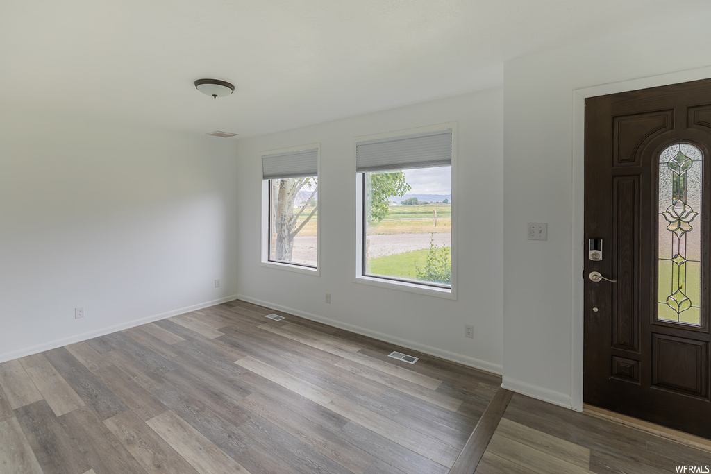 Hardwood floored foyer entrance with a wealth of natural light