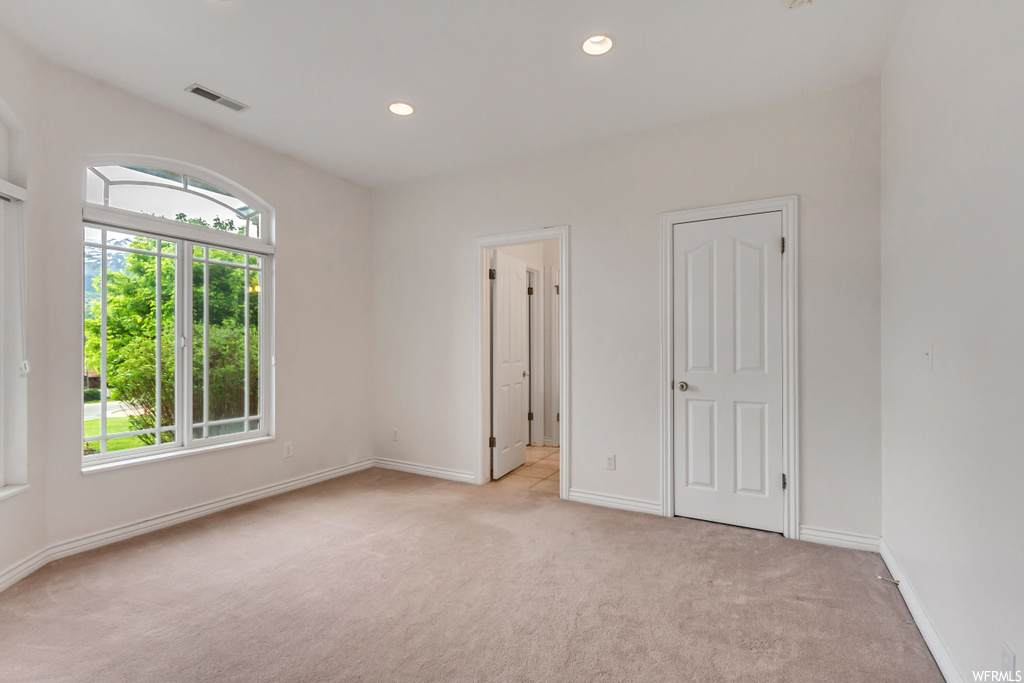 Spare room with natural light and carpet