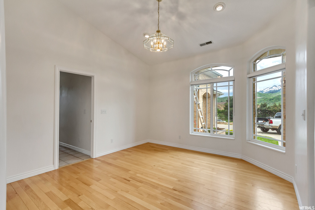 Empty room with hardwood floors and natural light