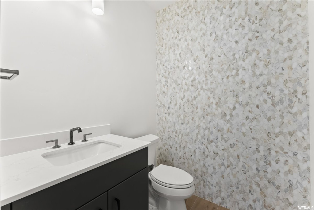 Half bathroom featuring toilet and vanity