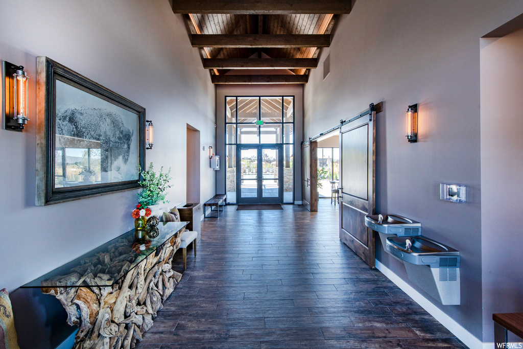 Hallway featuring a high ceiling and natural light