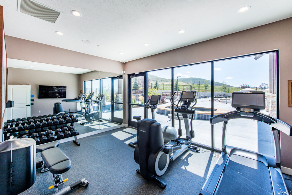 Exercise room with natural light and TV