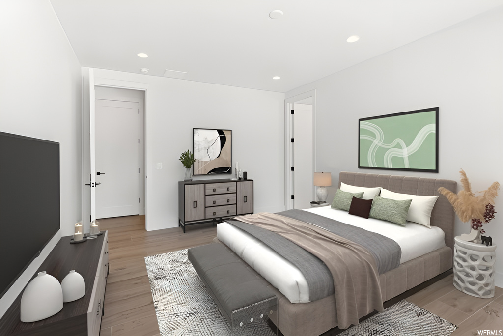 Hardwood floored bedroom featuring TV