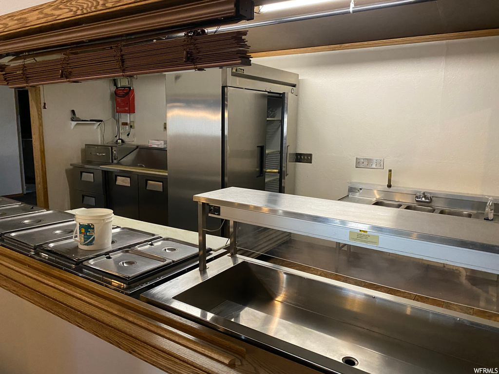 Kitchen featuring stainless steel finishes and light countertops