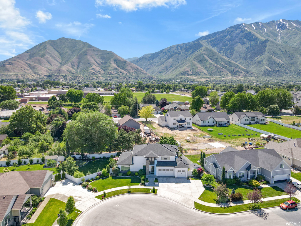 Property view of mountains featuring a yard