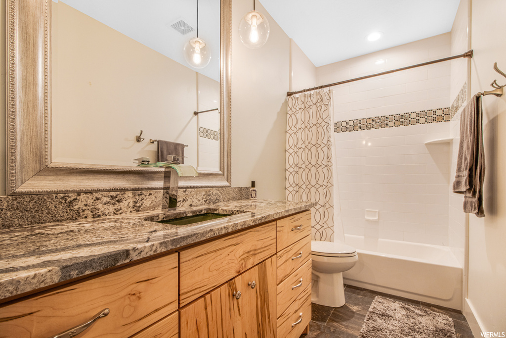 Full bathroom featuring tile flooring, mirror, toilet, shower curtain, vanity, and bathing tub / shower combination